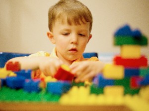 Child playing with Lego blocks