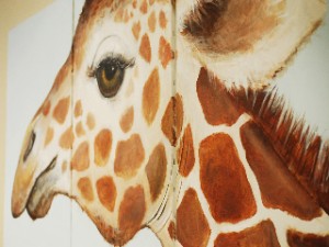 Large giraffe mural on office wall
